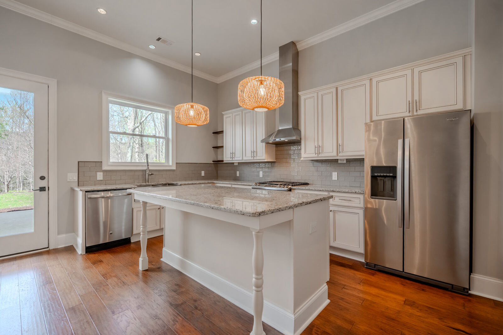 Kitchen with an oversized granite island and farmhouse sink