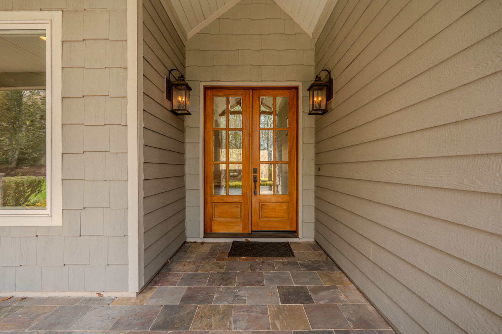 Double wood front doors on the slate front porch